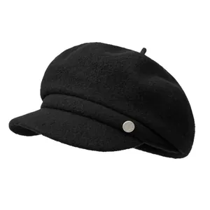 Classic black wool newsboy hat featuring vintage felt texture and silver metal button detail
