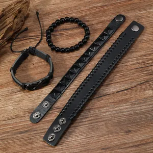 Dettaglio di set 4 bracciali in pelle nera con simbolo infinito e borchie metalliche