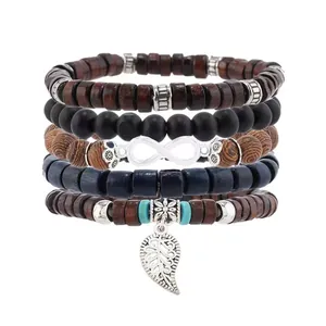 Detail von mehrlagigen Boho-Holzperlenarmbändern mit Blatt- und Unendlichkeitsanhänger