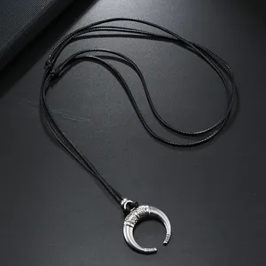Retro bull horn crescent moon necklace with geometric engravings on black cord string