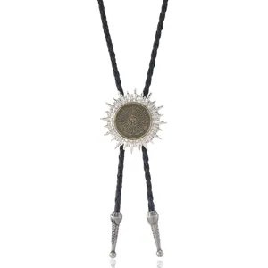 Close-up of vintage Sun of May bolo tie with silver rays and gold Argentine coin detail