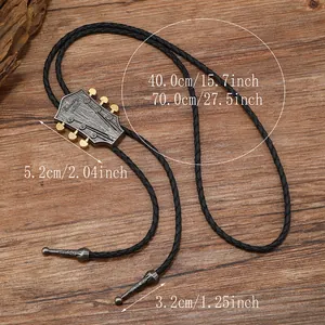 Detail of vintage guitar headstock bolo tie with country music engraving on wood