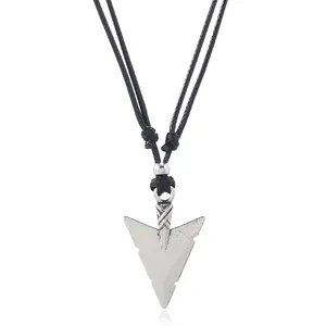 Detailed macro view of vintage arrow pendant on adjustable black braided cord necklace