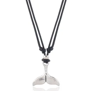 Close-up of a silver whale tail pendant on a black cord necklace for men
