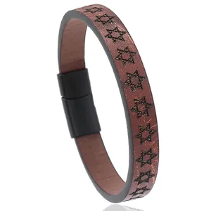 Close-up of brown leather bracelet with embossed hexagram pattern and magnetic clasp