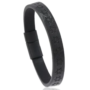 Close-up of black leather bracelet featuring embossed hexagram patterns and magnetic clasp