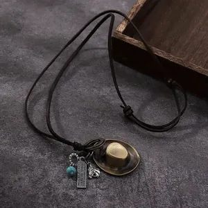 Western cowboy hat pendant necklace with horseshoe charm and turquoise bead on leather cord