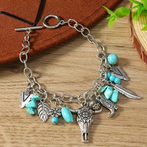 Western vintage turquoise charm bracelet with bull head and feather pendants