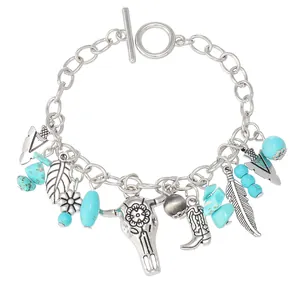 Western style turquoise bracelet with silver bull head and feather charms on chain