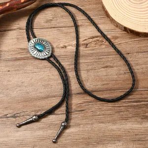 Western vintage bolo tie with turquoise gemstone on black braided leather cord necklace
