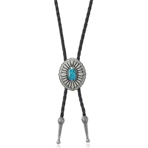 Detailed macro view of vintage silver bolo tie with sunflower metalwork and turquoise stone