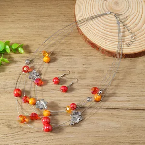 Detail of bohemian multilayer wire necklace and floral earrings with colorful resin beads