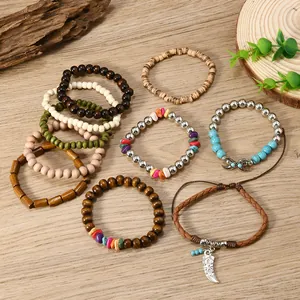Detail of bohemian multilayered wood bead bracelet set with silver bull horn pendant