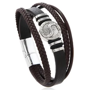 Detail of multi-layer leather bracelet with dragon tai chi magnet clasp and braided ropes