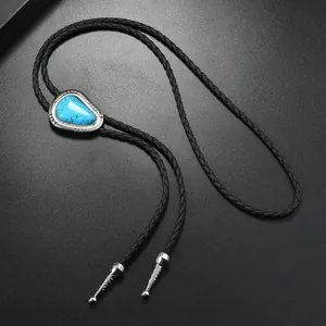Macro detail of Western bolo tie with turquoise stone and silver engraved metal base