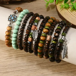 Macro view of bohemian wood bead bracelets with antique alloy pendants and floral engraving