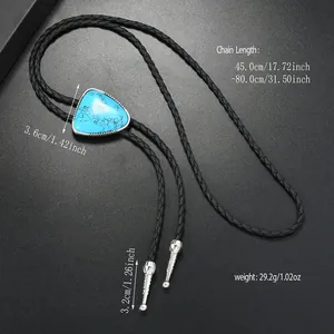 Detail of turquoise bolo tie with silver engraved tips and black braided leather cord