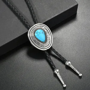Macro view of silver Bolo tie featuring turquoise stone and braided leather cord