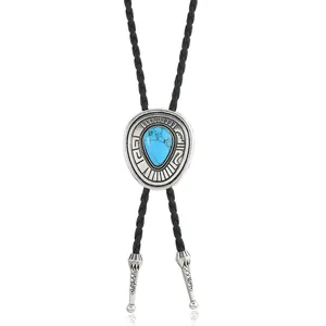 Detail of silver western bolo tie with blue turquoise inlay and braided leather cord