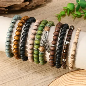 Detail of bohemian wood bead bracelet set with coconut shell beads and leaf charm