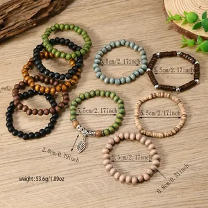 Detail shot of multi-layer bohemian wood bead bracelets with silver leaf pendant charms