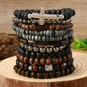 Macro shot of Bohemian multi-layer beaded bracelets with cross charm on wood