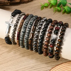 Detail of 10-piece bohemian beaded bracelet set with wooden beads and silver cross charm