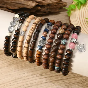 Close-up of Bohemian multilayered coconut shell wood beads with tree of life charms