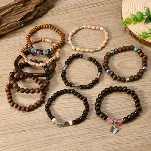 Detailed view of bohemian multilayer wood bead bracelets with tree of life charms