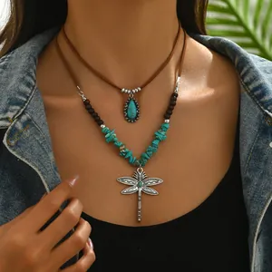 Two-layer bohemian necklace with turquoise dragonfly pendant and wooden beads on model