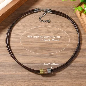 Detail of layered brown cord necklace with metallic pendants and precise size markings