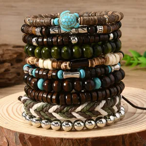 Detail of bohemian multilayer stretch bracelets with coconut shell, wood beads and turtle charm