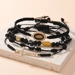 Dettaglio set 4 bracciali neri intrecciati con croce e perline contro il malocchio