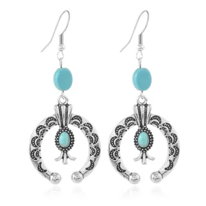 Detailed view of bohemian silver alloy earrings with turquoise stone insets