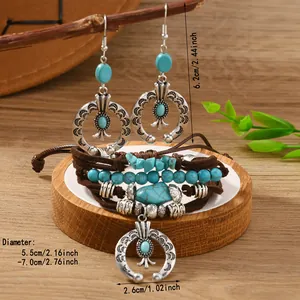 Detail of bohemian turquoise jewelry set featuring bull head charms on rustic wood background