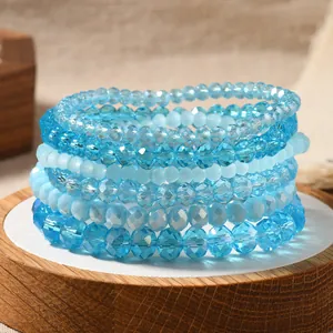 Detailed macro view of seven layered blue faceted crystal beads stretch bracelets set