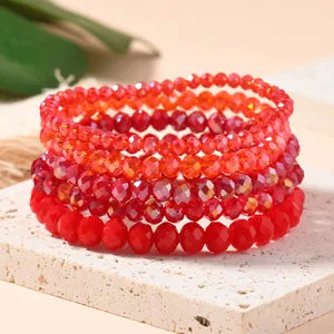 Close-up of red multilayer faceted crystal stretch bracelets on a stone display