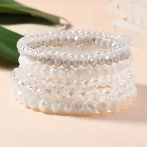 Close-up of multi-layer stretch bracelets with faceted crystal beads in white and grey tones