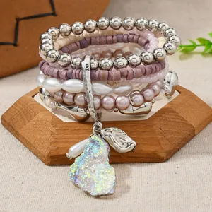 Detail view of multi-layer Bohemian beaded bracelets with shell charms and metal accents