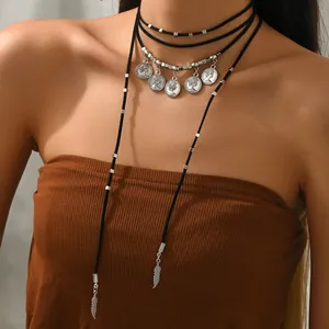Gypsy layered choker with silver coins and feather pendants for a vintage look