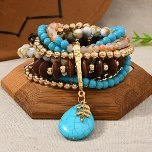 Detail of bohemian multilayer beaded bracelet with turquoise pendant and wood beads