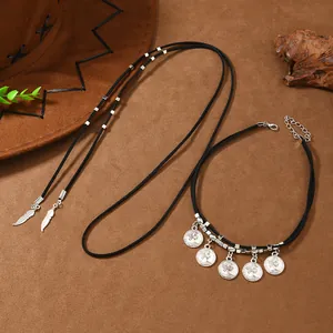 Bohemian multi-layer necklace with silver feather and coin charms on black suede cord