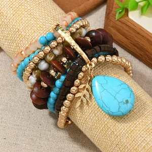 Bohemian multilayer bracelet set with turquoise beads and golden leaf pendant on display