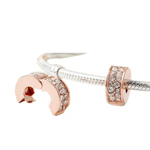 Rose gold pave crystal charm clip and spacer bead on a silver snake chain bracelet