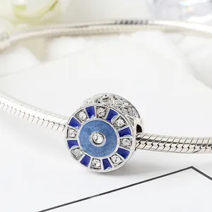 Blue sunburst charm bead in silver with enamel and zircon on a snake chain bracelet