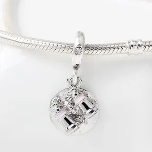 Silver bead charm with pink enamel coffee cup design on a snake chain bracelet