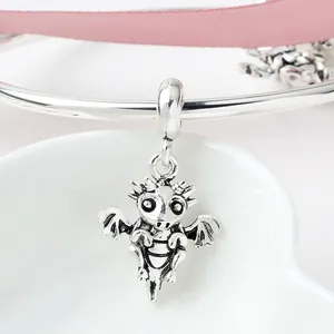 Silver dragon charm with vintage wings on a polished bracelet for jewelry making