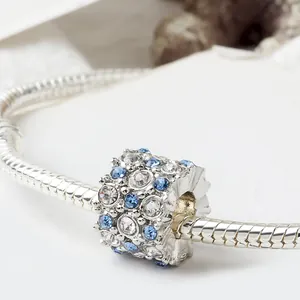 Detail einer Silberperle mit blauen und weißen Kristallen auf einem Schlangenarmband
