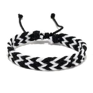 Close-up of black and white braided wax cord bracelet with adjustable sliding knot
