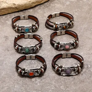 Detail of bohemian layered leather bracelets with multi-color stones and magnetic buckle